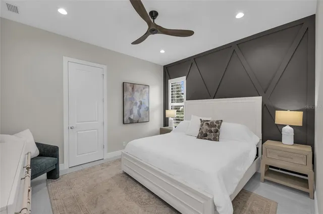 a front view of a house with a yard and potted plants
