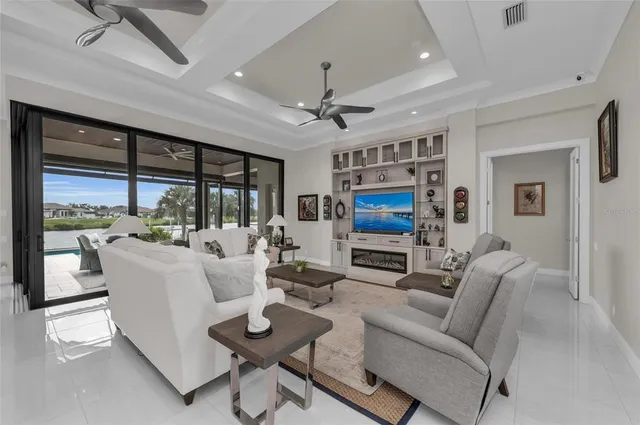 a living room with furniture and a chandelier