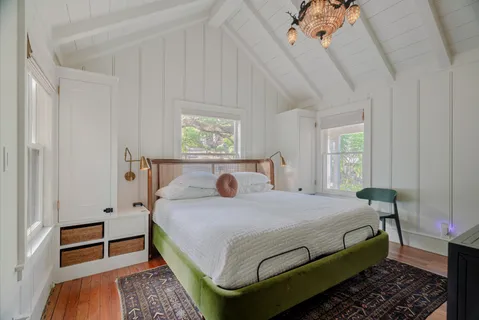 a bedroom with a bed and a window