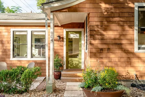 a front view of a house with a potted plant