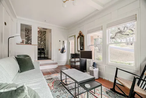 a living room with furniture a fireplace and a window