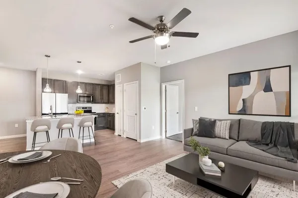 a living room with furniture and kitchen view