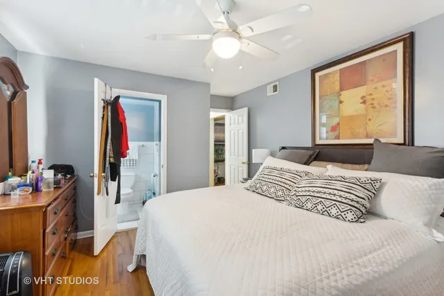 a bedroom with a bed and dresser with mirror