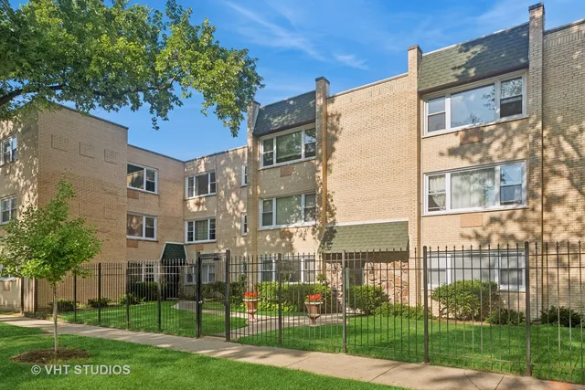 a view of a brick building next to a yard