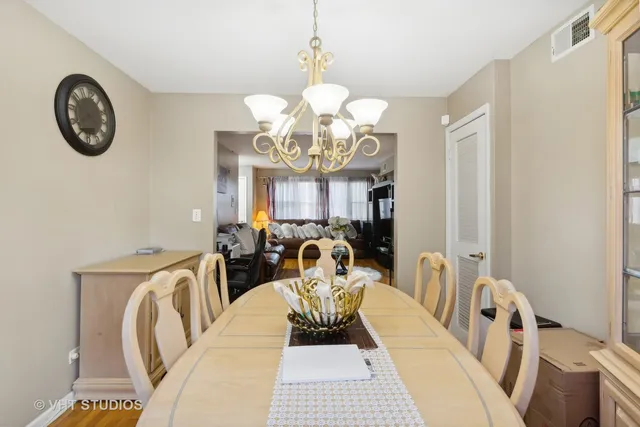 a view of a dining room with furniture and a chandelier