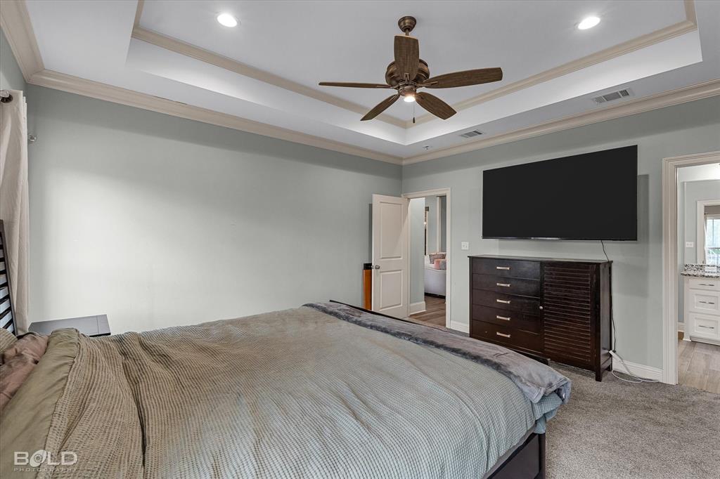 143 Oak Alley Road Stonewall, LA 71078 - Photo 20 of 38 Tray ceiling with crown molding, recessed lighting, ceiling fan, and light gray wall paint