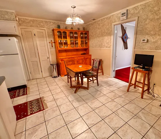a view of a livingroom with furniture a flat screen tv and couches