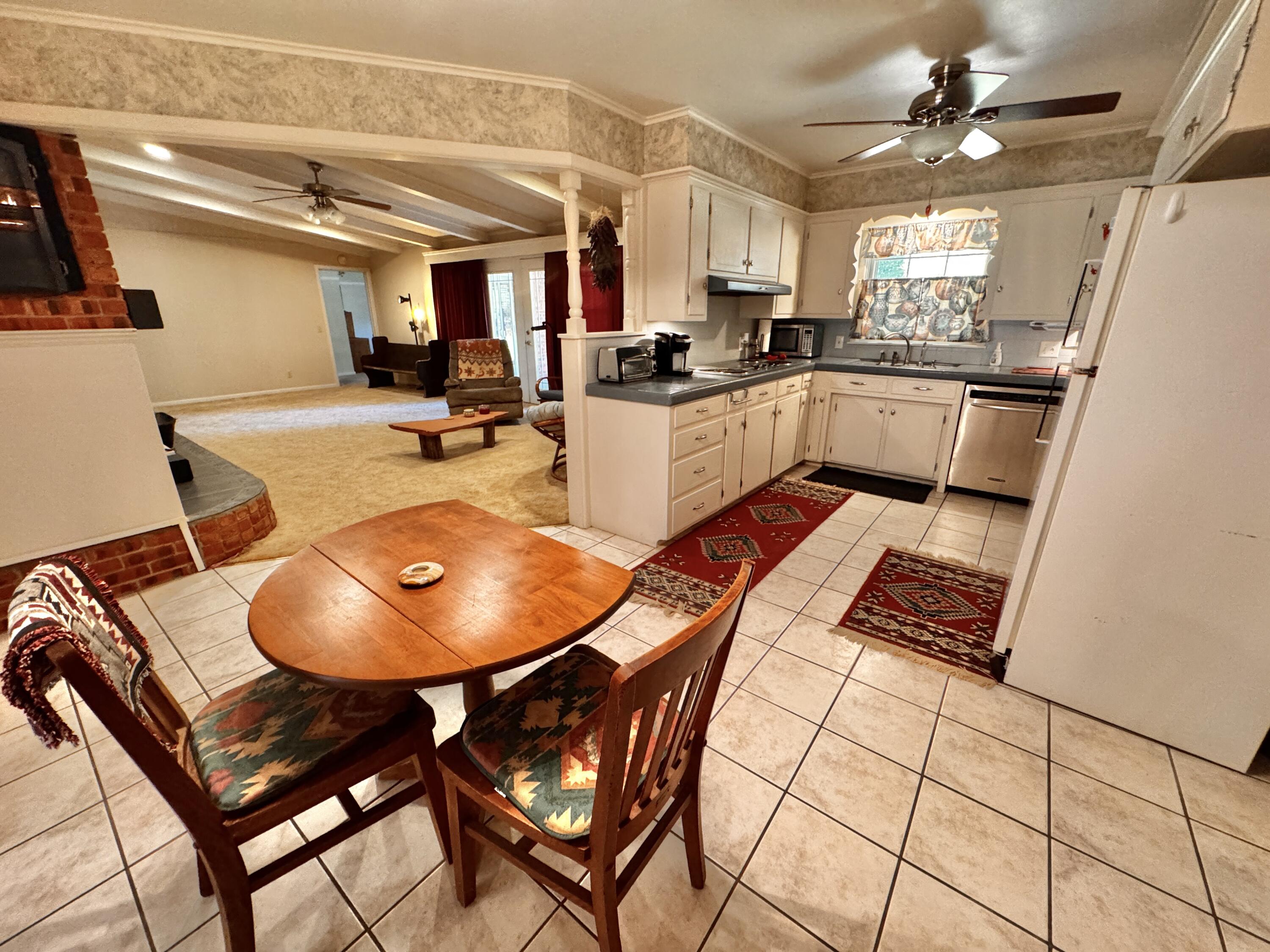 1403 Amarillo Plainview, TX 79072 - Photo 13 of 48 a kitchen with stainless steel appliances granite countertop a sink dishwasher a refrigerator a microwave oven with a dining table and chairs