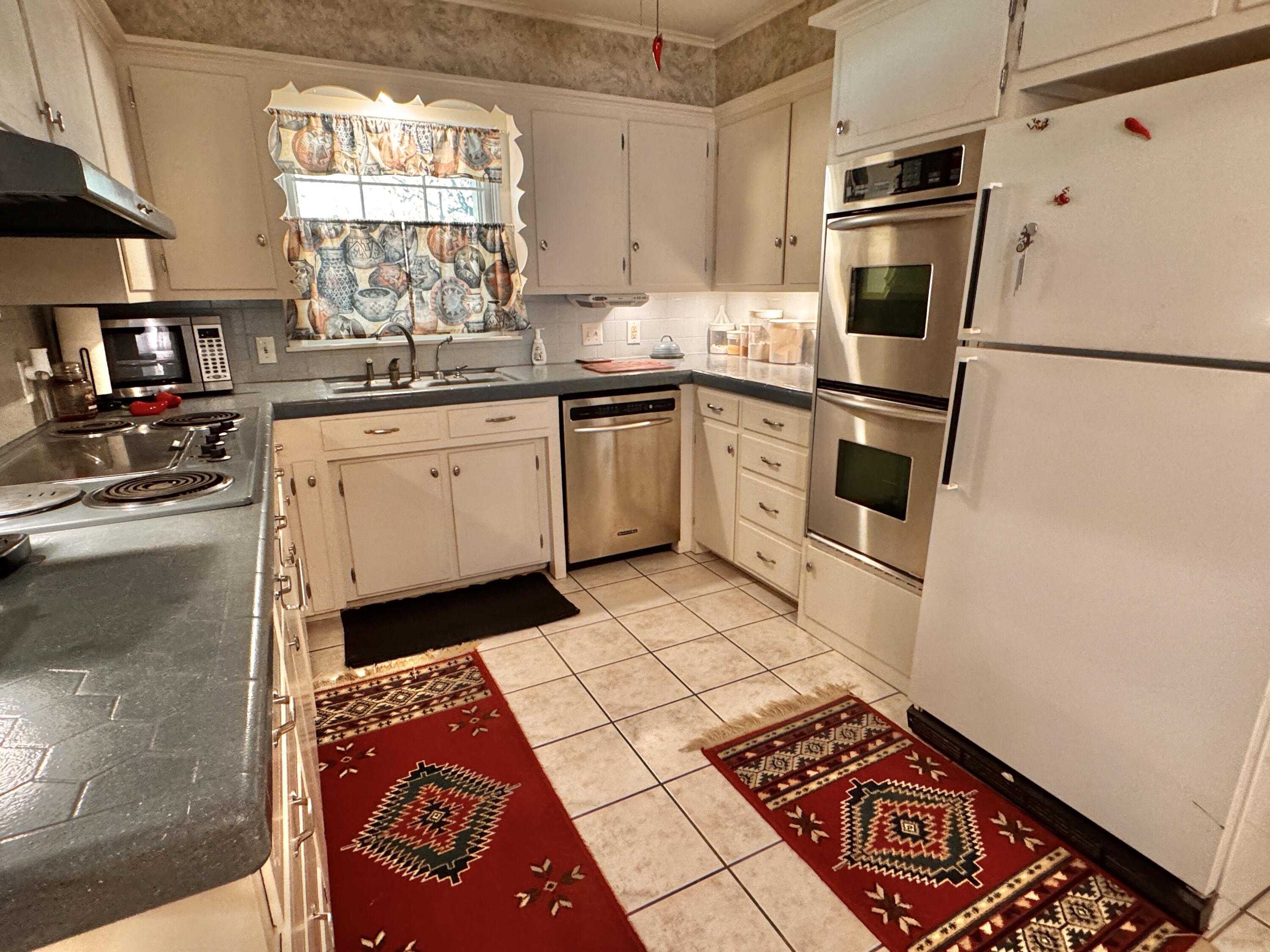 1403 Amarillo Plainview, TX 79072 - Photo 16 of 48 a kitchen with a sink a stove a refrigerator and cabinets