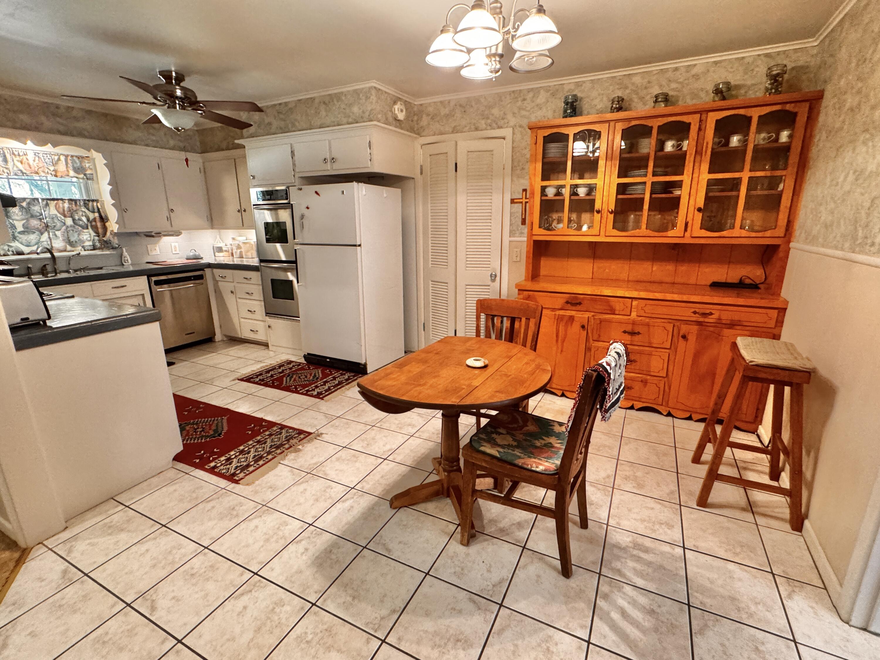 1403 Amarillo Plainview, TX 79072 - Photo 17 of 48 a kitchen with stainless steel appliances kitchen island granite countertop a table and chairs in it