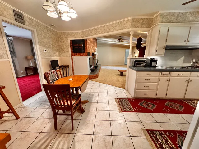 a kitchen with stainless steel appliances kitchen island granite countertop a sink and cabinets
