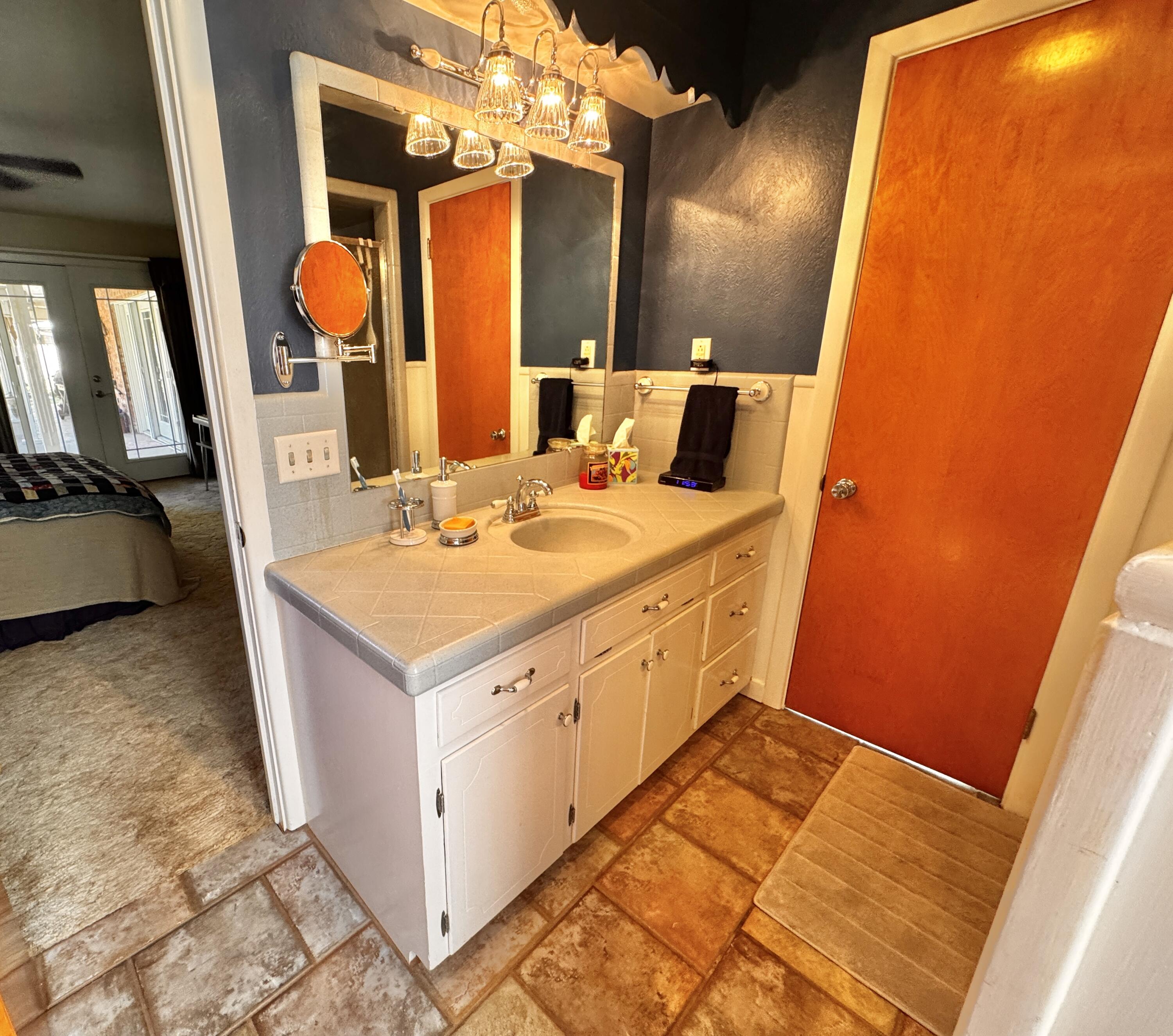 1403 Amarillo Plainview, TX 79072 - Photo 29 of 48 a bathroom with a sink vanity and mirror