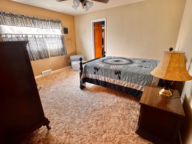 a bed sitting in a bedroom next to a window