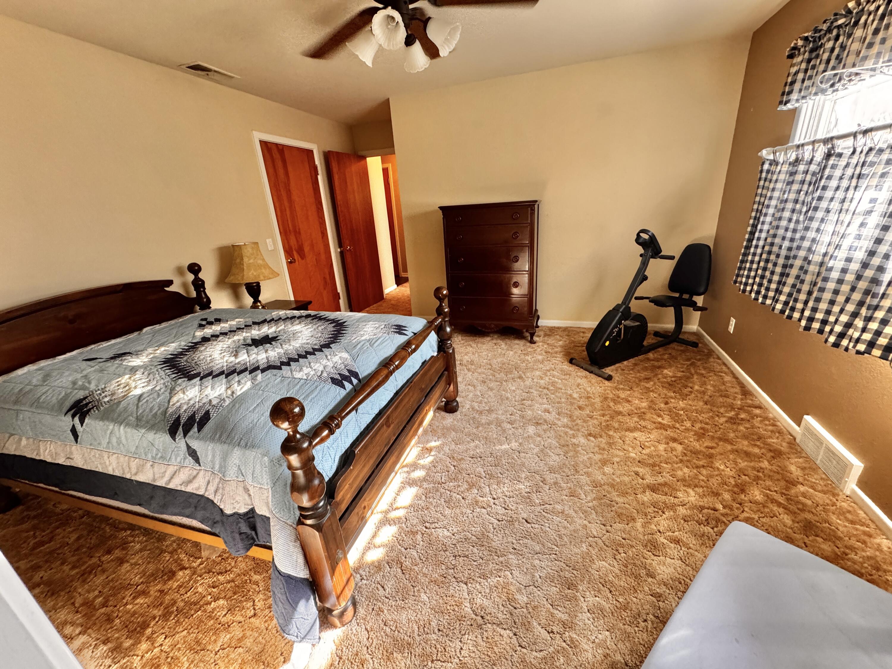 1403 Amarillo Plainview, TX 79072 - Photo 32 of 48 a bed sitting in a bedroom next to a window