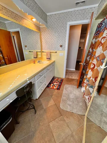 a bathroom with a sink mirror and a bath tub