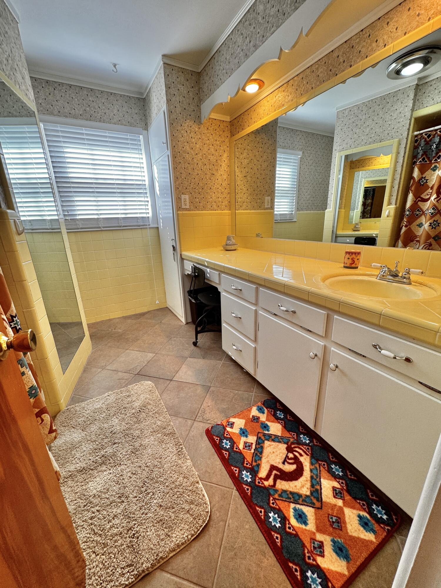 1403 Amarillo Plainview, TX 79072 - Photo 34 of 48 a bathroom with a sink mirror and a bath tub