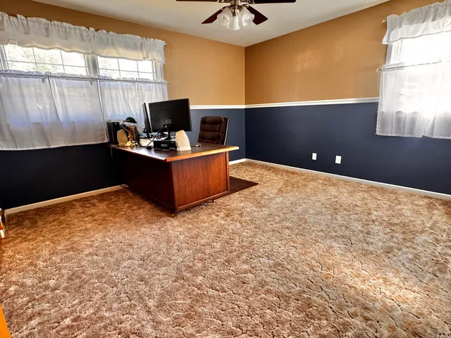 a backyard of a house with wooden floor and outdoor seating