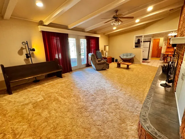 a view of a livingroom with furniture and a ceiling fan