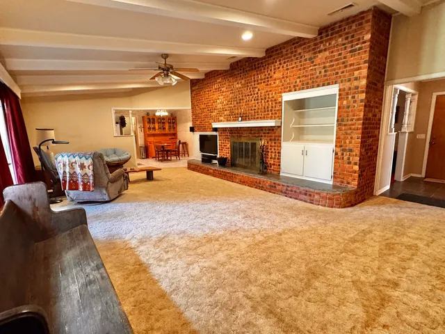 a view of a livingroom with furniture and a fireplace