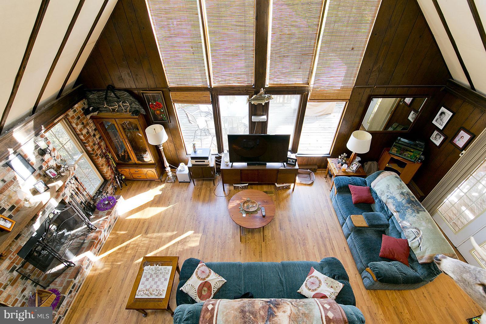 a living room with furniture and a floor to ceiling window
