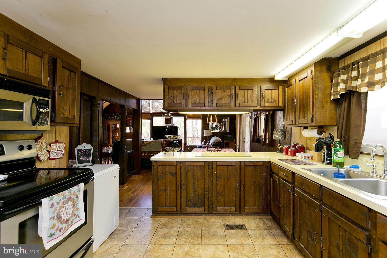496 Audubon Road Hedgesville, WV 25427 - Photo 3 of 30 a kitchen with a sink stove and cabinets