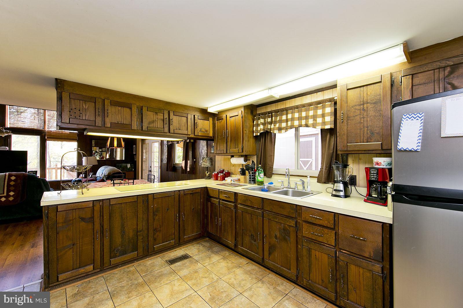 496 Audubon Road Hedgesville, WV 25427 - Photo 4 of 30 a kitchen with a sink stove and cabinets