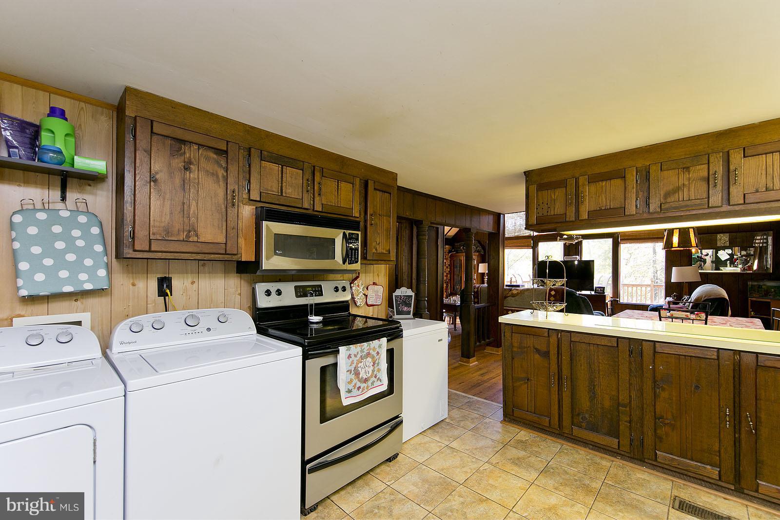 496 Audubon Road Hedgesville, WV 25427 - Photo 6 of 30 a kitchen with a sink a stove and cabinets