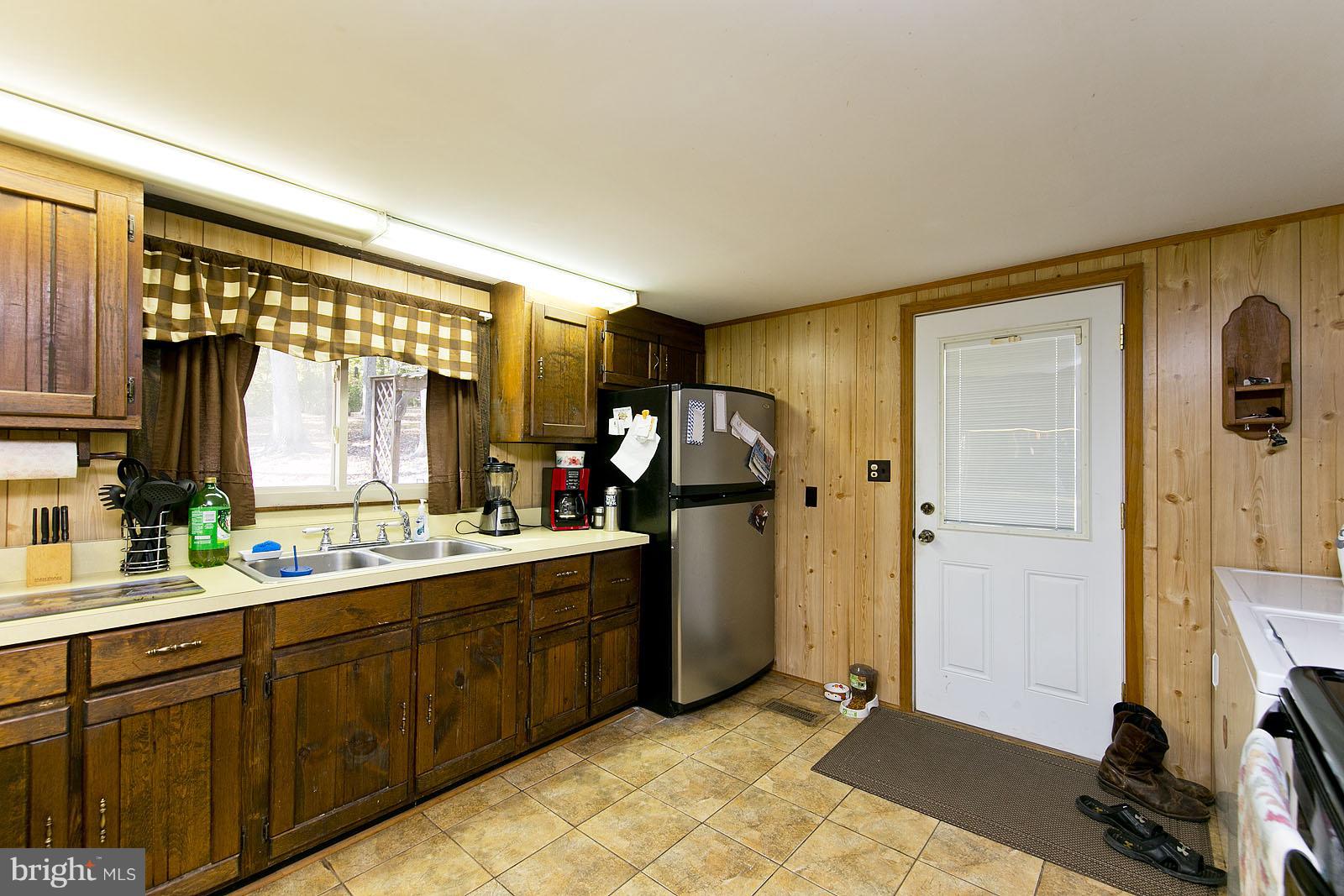 496 Audubon Road Hedgesville, WV 25427 - Photo 7 of 30 a kitchen with a sink refrigerator and window