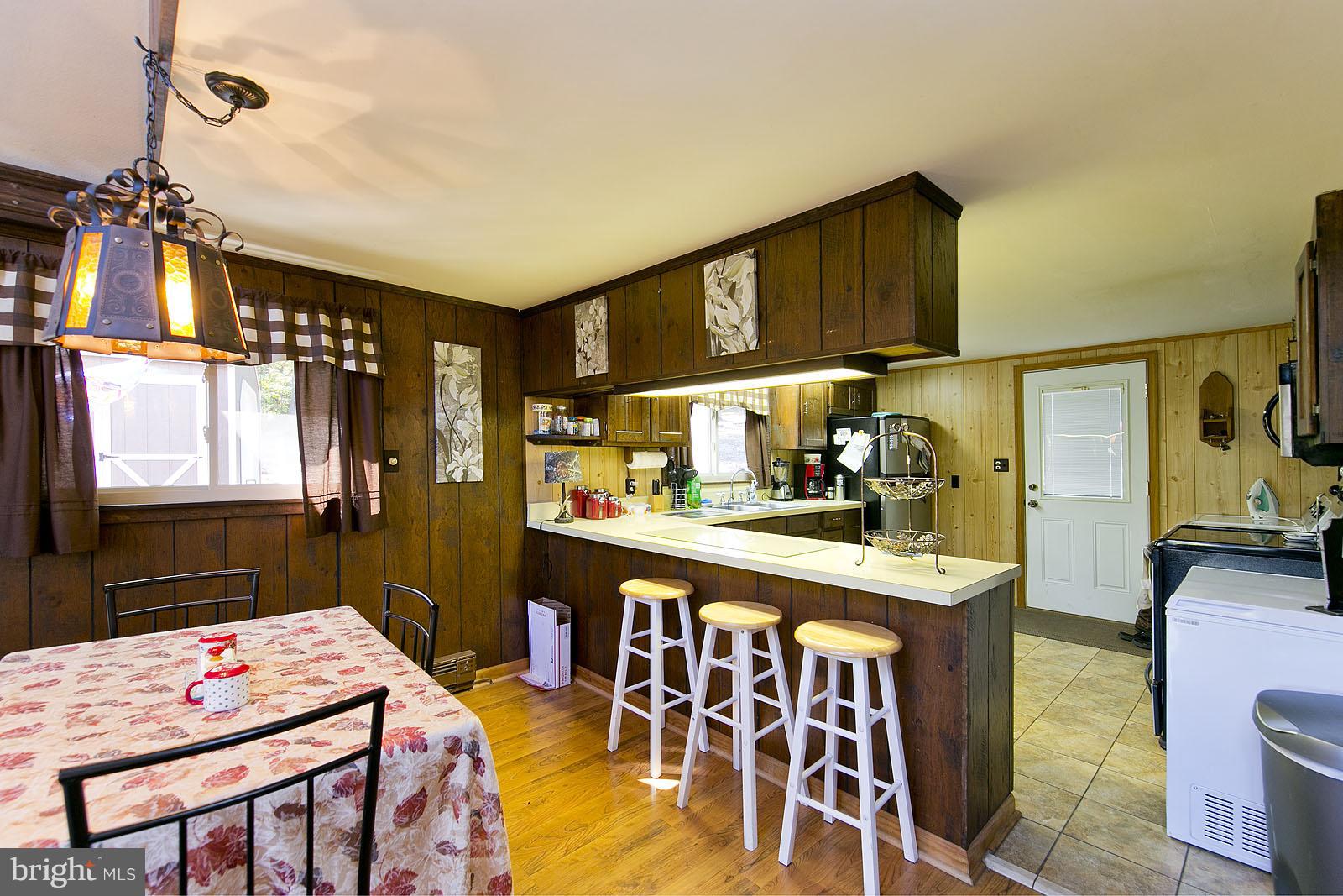 496 Audubon Road Hedgesville, WV 25427 - Photo 10 of 30 a kitchen that has a table and chairs in it