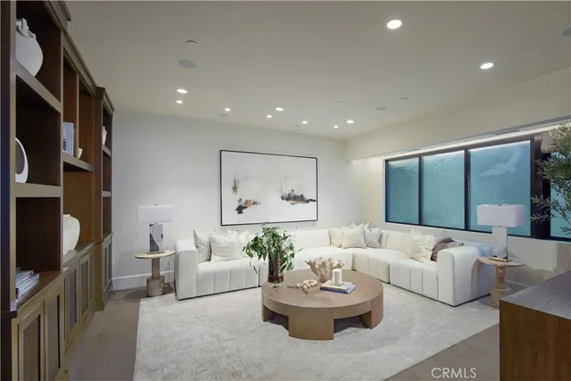 a living room with furniture large window and a flat screen tv