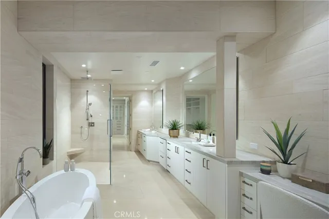 a bathroom with a granite countertop sink a mirror and a shower