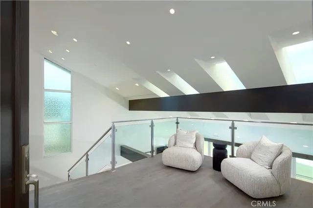 a very nice looking living room with a large window a table and chairs