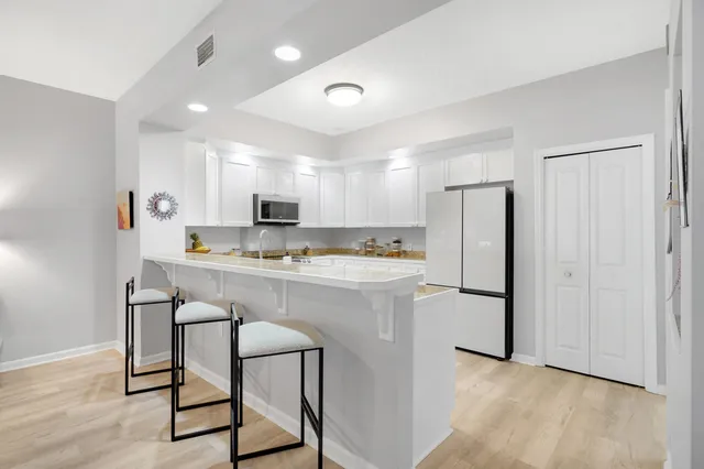a kitchen with refrigerator cabinets and a counter top space