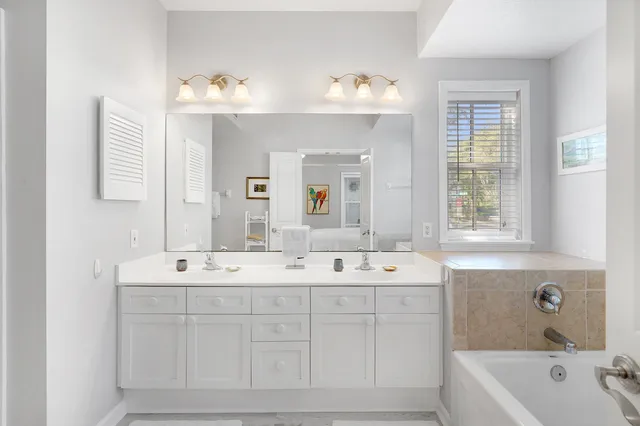 a spacious bathroom with a double vanity sink mirror and