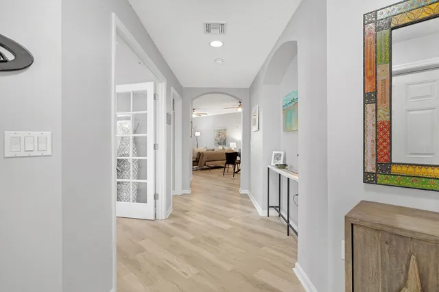 a view of a hallway with furniture and a livingroom