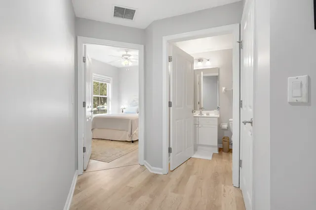 wooden floor with a bathroom and a sink