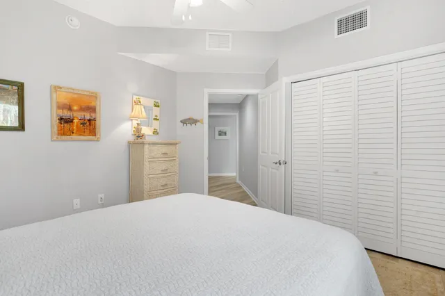 a bedroom with a bed and painting on the wall