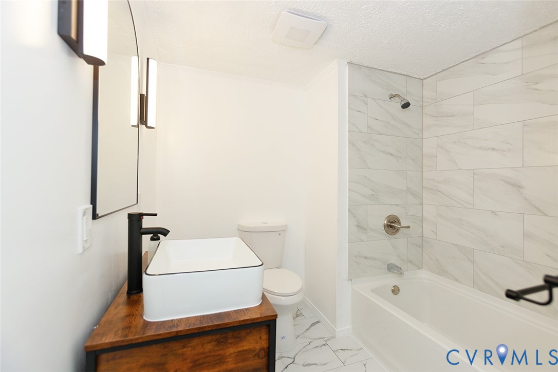 925 Fluvanna Road Newport News, VA 23601 - Photo 15 of 25 a bathroom with a sink a toilet and shower