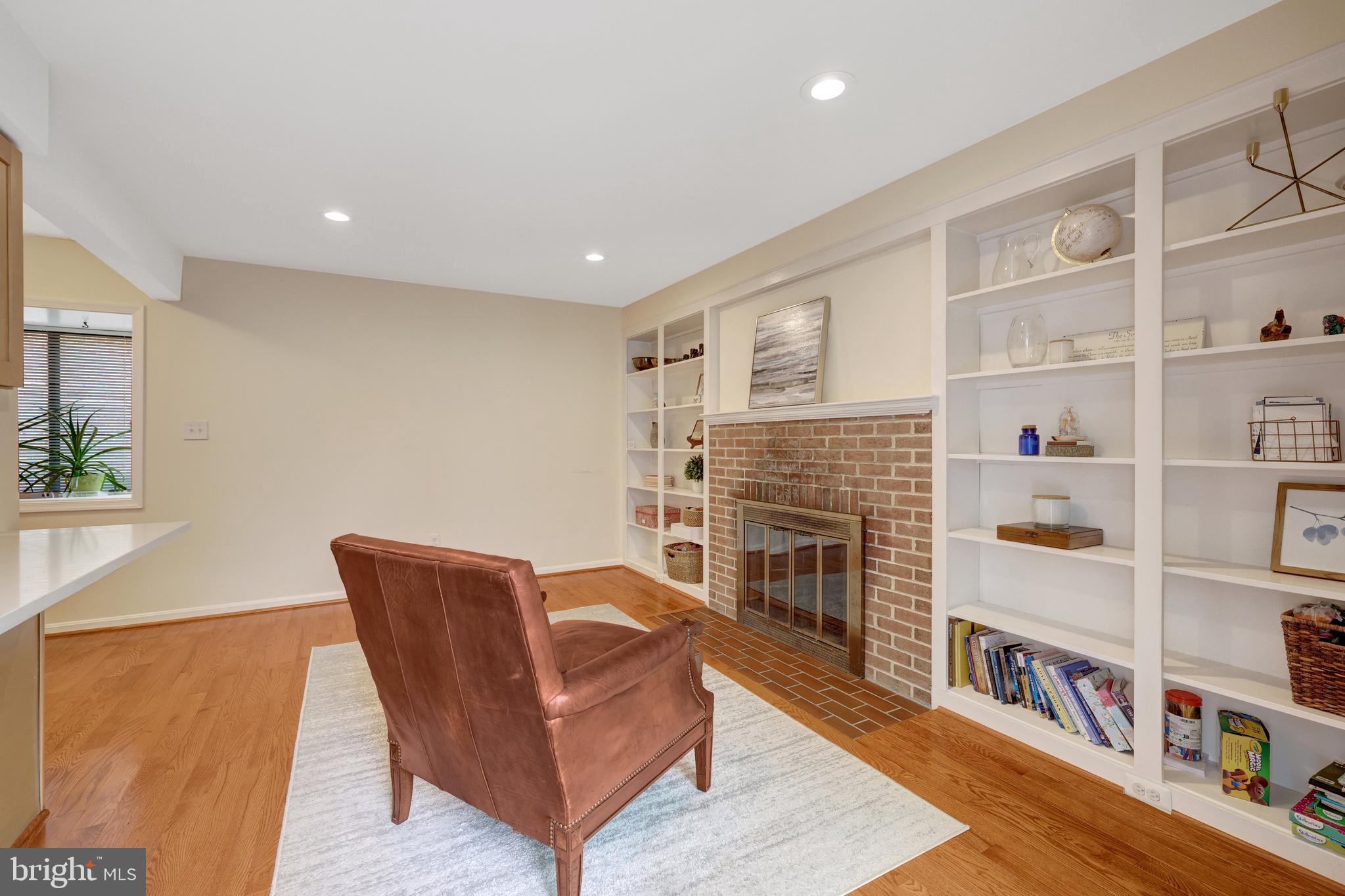 6868 Chelsea Road McLean, VA 22101 - Photo 15 of 41 a living room with fireplace furniture and a book shelf