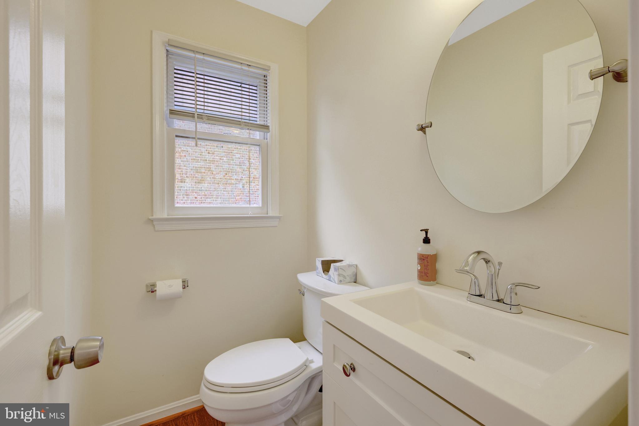 6868 Chelsea Road McLean, VA 22101 - Photo 19 of 41 a bathroom with a sink a toilet and a mirror