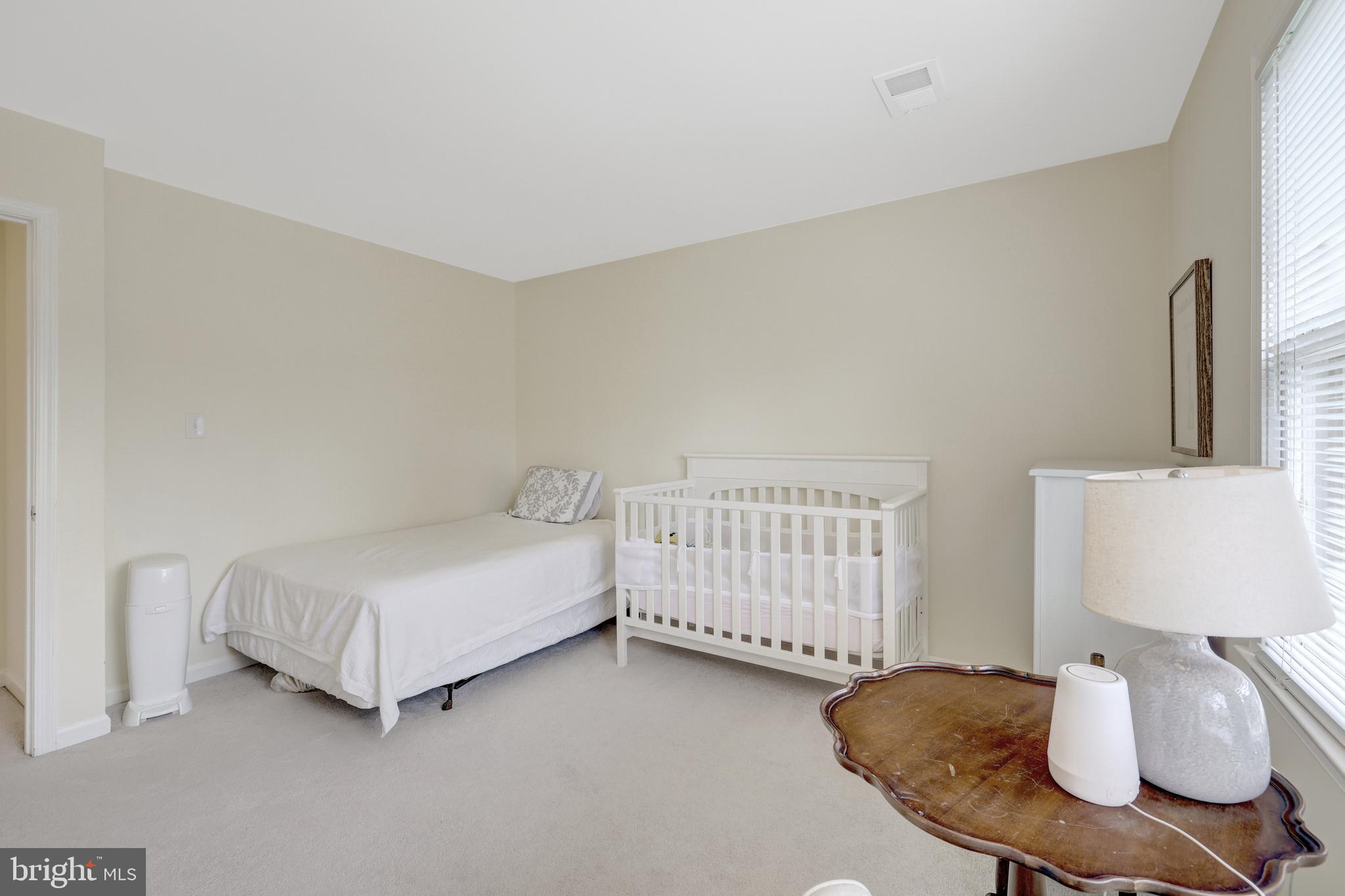 6868 Chelsea Road McLean, VA 22101 - Photo 21 of 41 a bedroom with a bed and a dresser with wooden floor