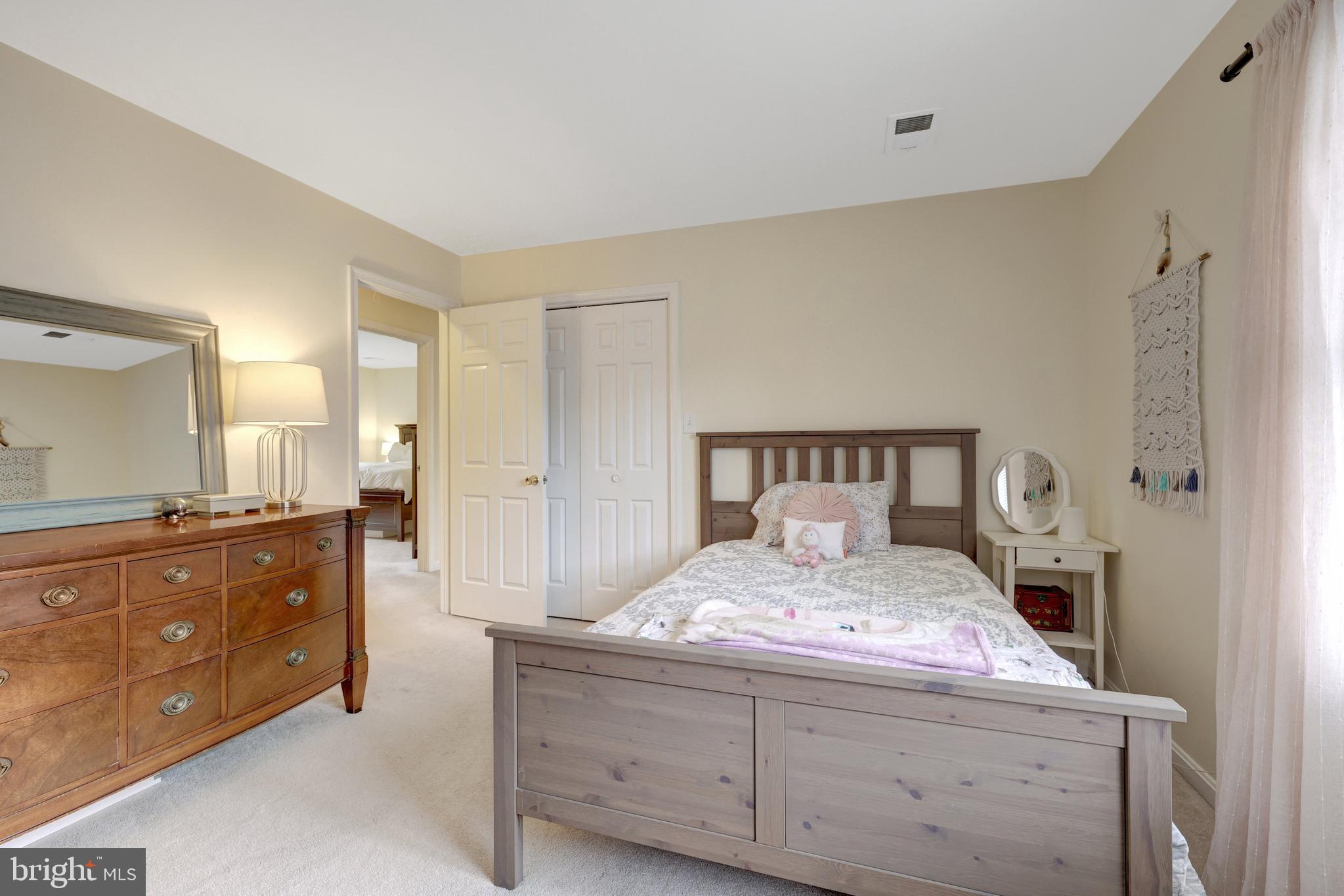 6868 Chelsea Road McLean, VA 22101 - Photo 23 of 41 a bedroom with a large bed and a dresser