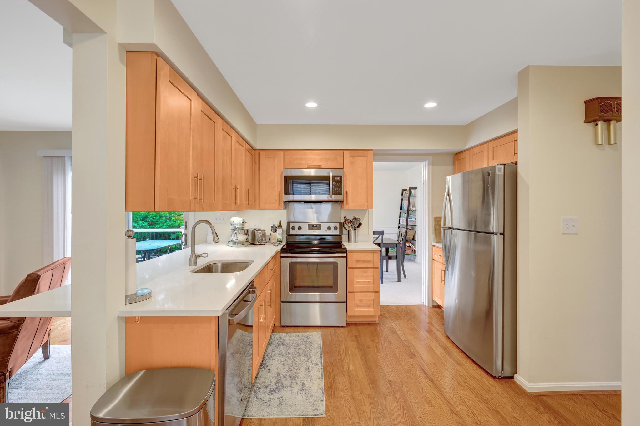 6868 Chelsea Road McLean, VA 22101 - Photo 9 of 41 a kitchen with stainless steel appliances granite countertop a refrigerator a stove top oven a sink and dishwasher