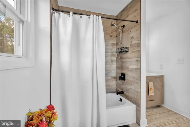 a bathroom with a shower curtain and a bathtub