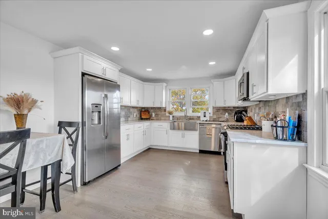 a kitchen with refrigerator and cabinets