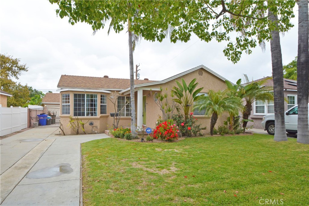 12301 Rives Avenue Downey, CA 90242 - Photo 2 of 20 a front view of a house with garden