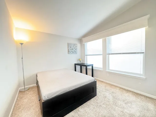 a bedroom with a bed and a window