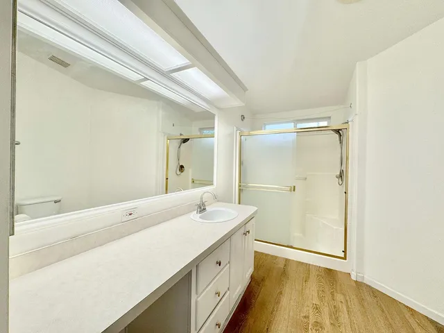 a bathroom with a double vanity sink and mirror