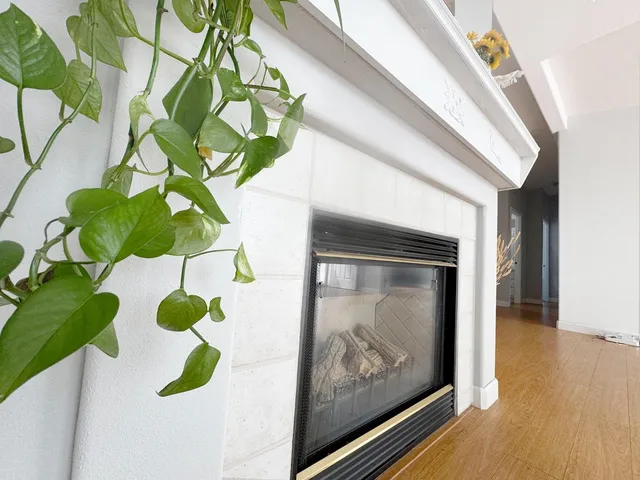 a vase of flowers sitting on a wooden floor