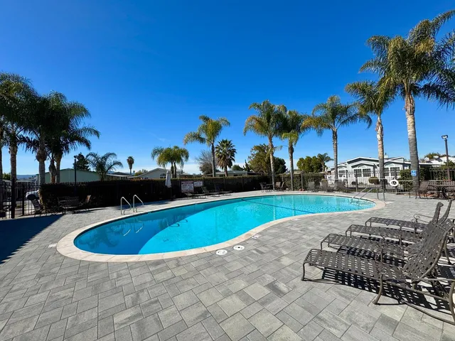 a view of swimming pool with outdoor seating and plants